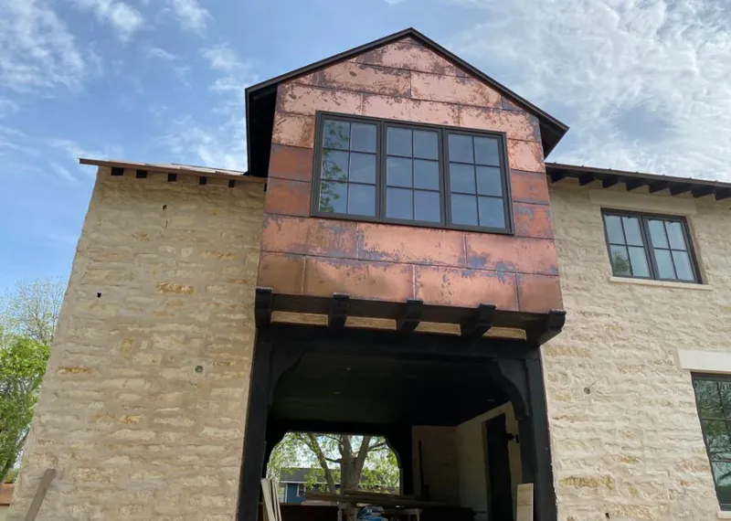 Copper metal panel facade on a stone building for Roof Repair in Merrillville